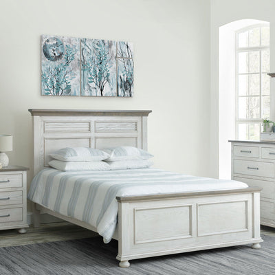 Antique white panel bed with weathered gray top caps and bun feet, styled with striped bedding and wall art