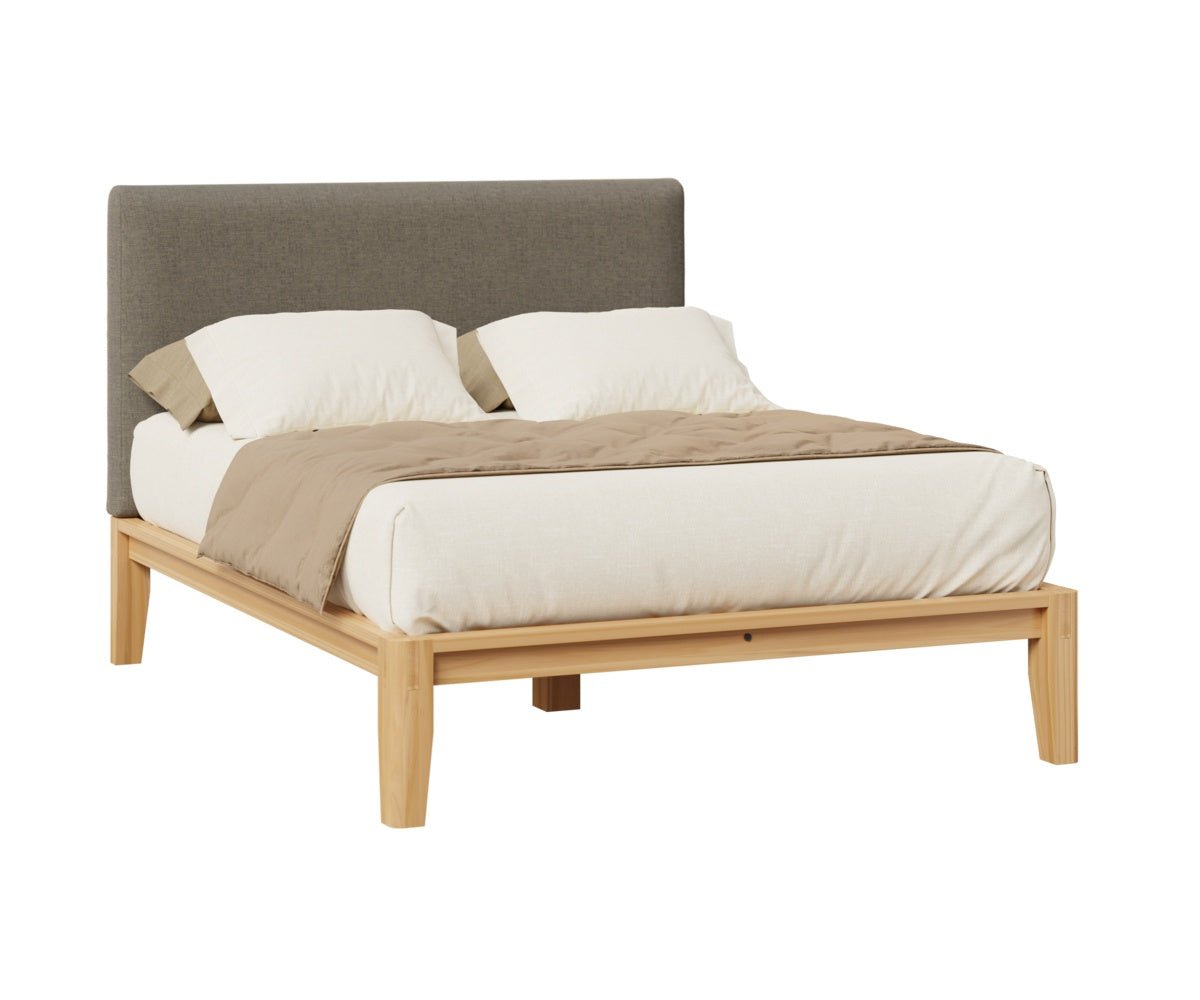 Platform bed with a gray upholstered headboard panel on a natural wood frame, dressed with cream and tan bedding