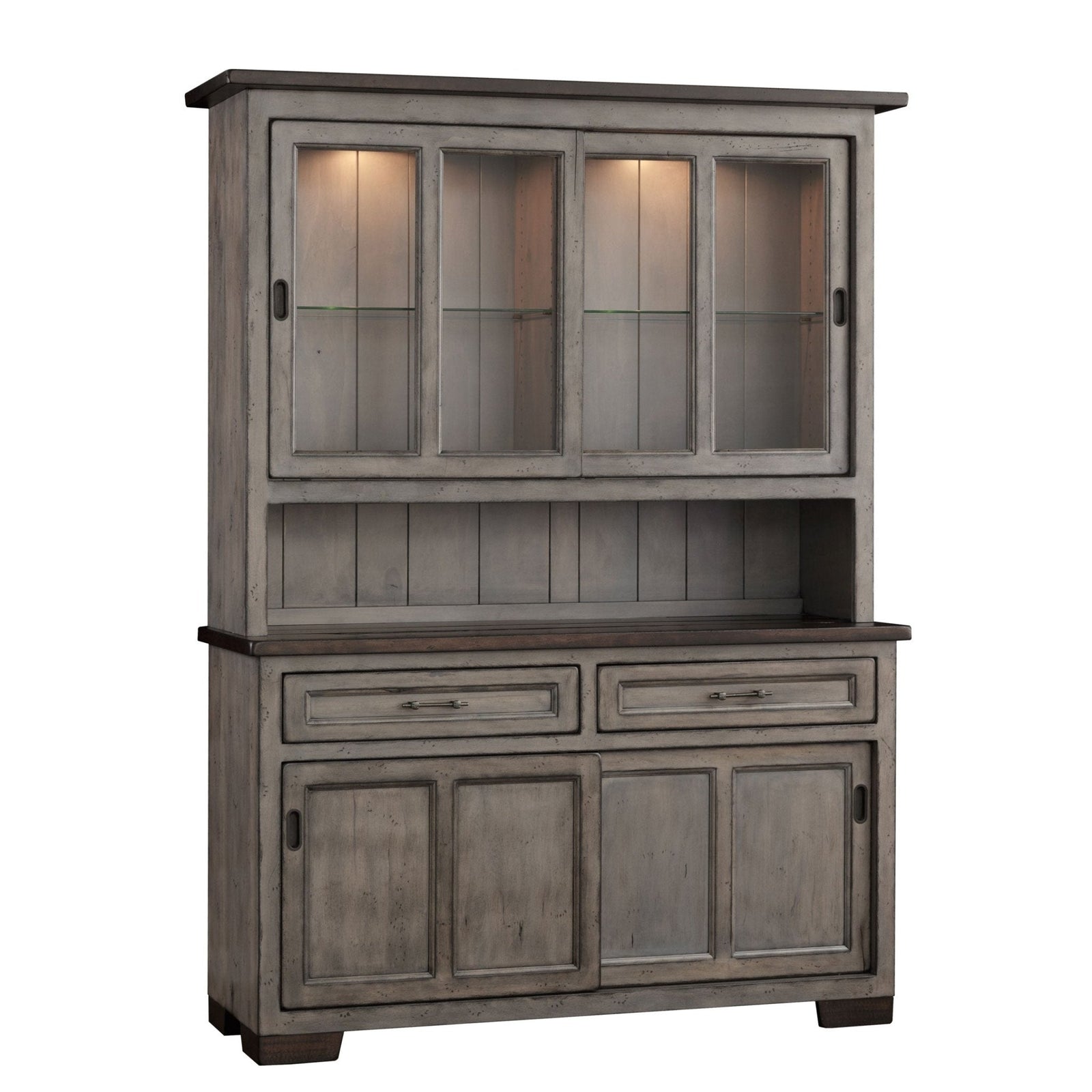 Weathered gray 63 inch hutch with lit sliding glass doors of white dishes, dark plank top and paneled base in a brick dining room