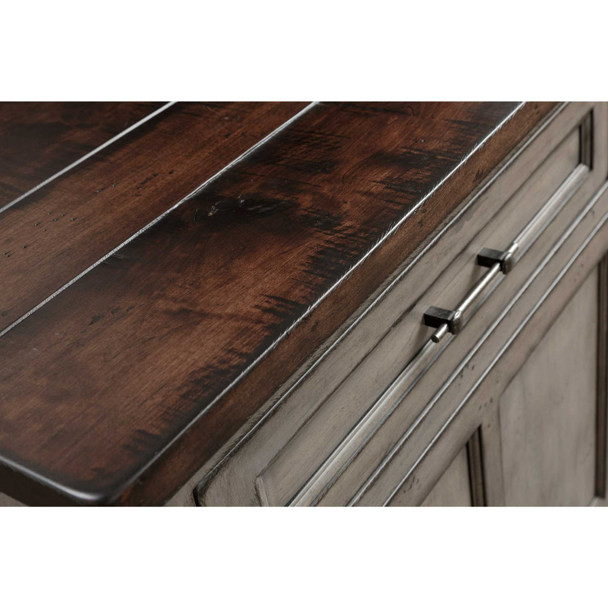 Close-up of the hutch's dark plank top with rope edge detail beside the weathered gray drawer and iron bar pulls