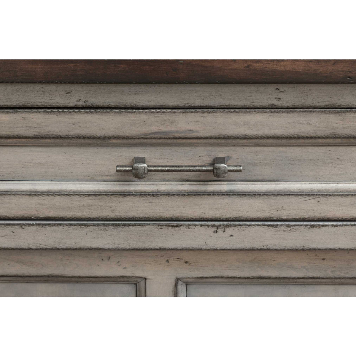 Detail of the gray hutch drawer with a slim iron bar pull, molded trim and dark walnut top edge above