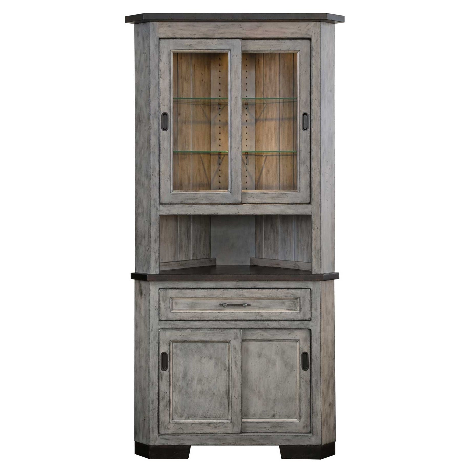 Weathered gray 31 inch corner hutch with lit sliding glass doors, dark top, one drawer and paneled base in a rustic corner
