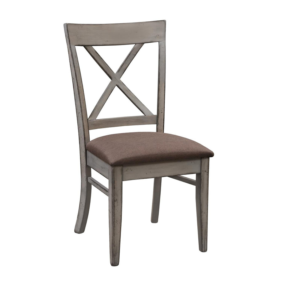 Distressed gray X back dining side chair with brown upholstered seat, curved crest rail and side stretchers