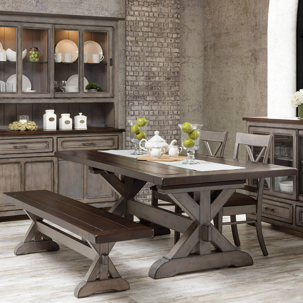 Farmhouse dining room with the two-tone X trestle table, matching bench, X back chairs, gray hutch and server on brick