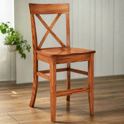 Oak X back bar chair with a curved crest rail, contoured wood seat, footrest stretchers and tapered legs
