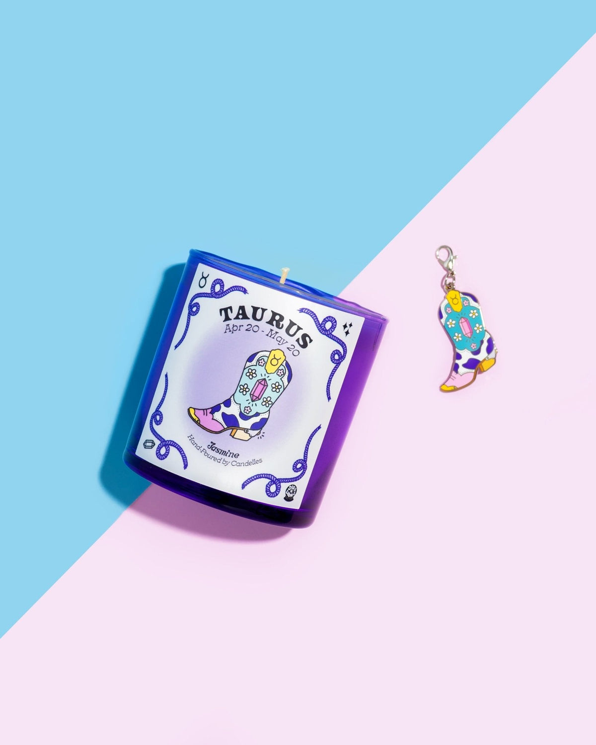 Jasmine Taurus zodiac candle in a purple glass tumbler beside a matching cowboy boot charm on pink and blue paper