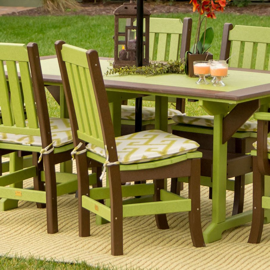 Lime green and brown poly dining chairs with patterned cushions at a matching patio table on the lawn