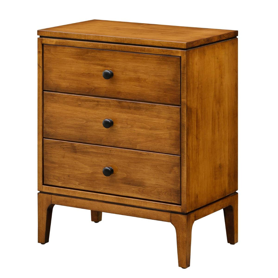 Three-drawer mid century night table in maple with black knobs, flush drawer fronts and tapered legs