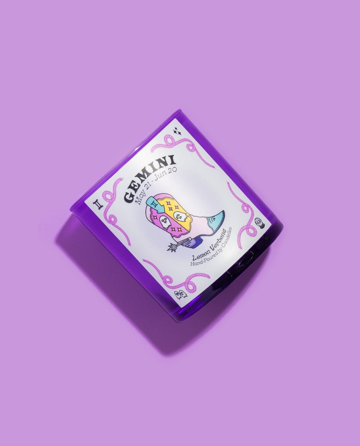 Gemini lemon verbena zodiac candle angled on lilac with a pastel illustrated cowboy boot on the front label