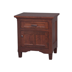 Cherry nightstand with one drawer above a raised panel door, dark knobs and tapered legs on white