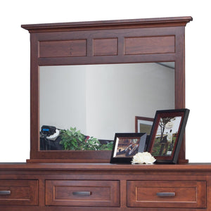 Wide cherry dresser mirror with paneled header and crown molding shown on a nine-drawer dresser with photo frames
