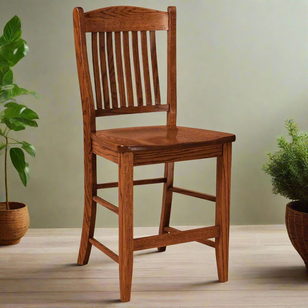 Lyndon oak bar chair with vertical slat back, contoured wood seat and footrest stretchers between tapered legs