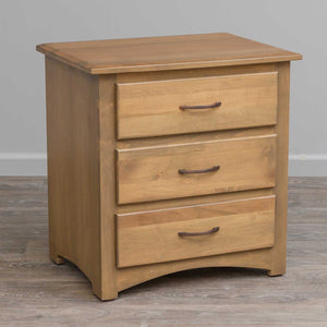 Natural maple three drawer nightstand with bronze arched pulls and a curved apron, on wood flooring