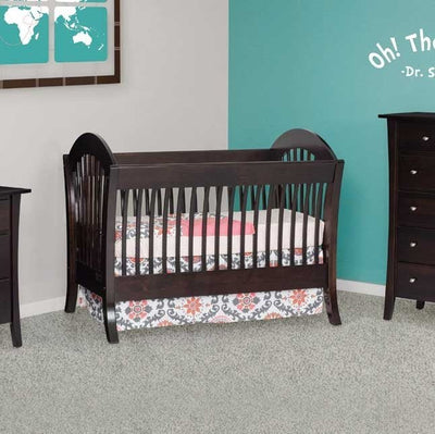 Espresso sleigh style convertible crib with arched slatted ends and flared feet in a teal and gray nursery