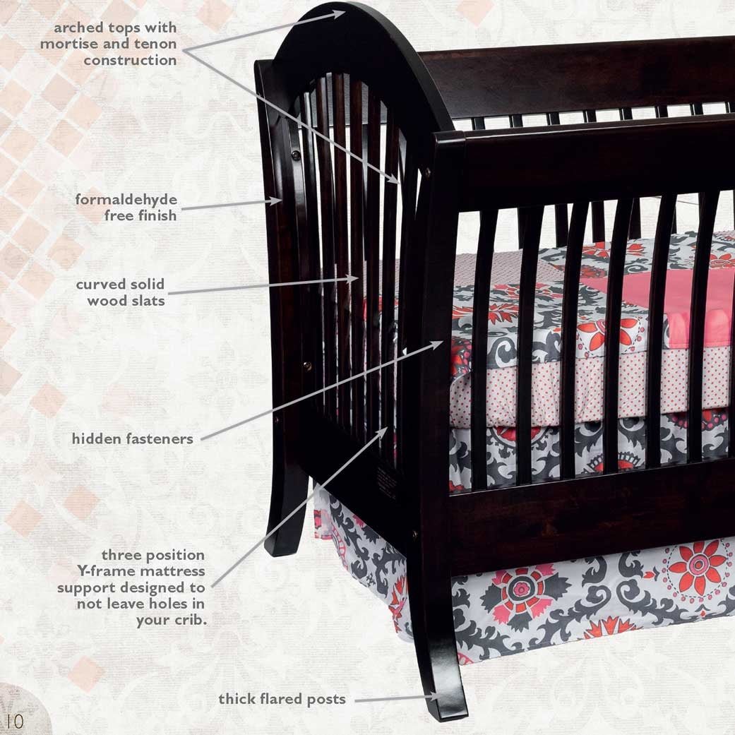 Callout diagram of the espresso sleigh crib noting arched tops, curved solid wood slats and thick flared posts
