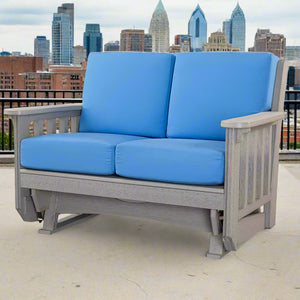 Driftwood gray poly Mission double glider loveseat with deep blue cushions on a rooftop deck