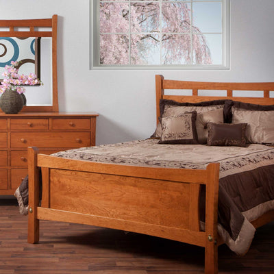 Cherry panel bed with a slatted arch headboard beside a dresser and mirror in a bright bedroom