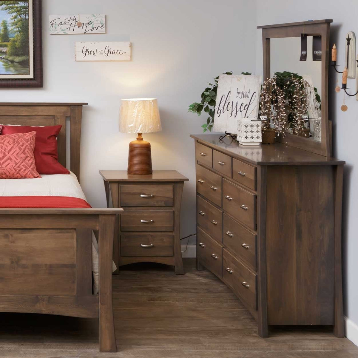 Gray brown bedroom scene with a curved leg nightstand, nine drawer dresser and mirror beside a panel bed
