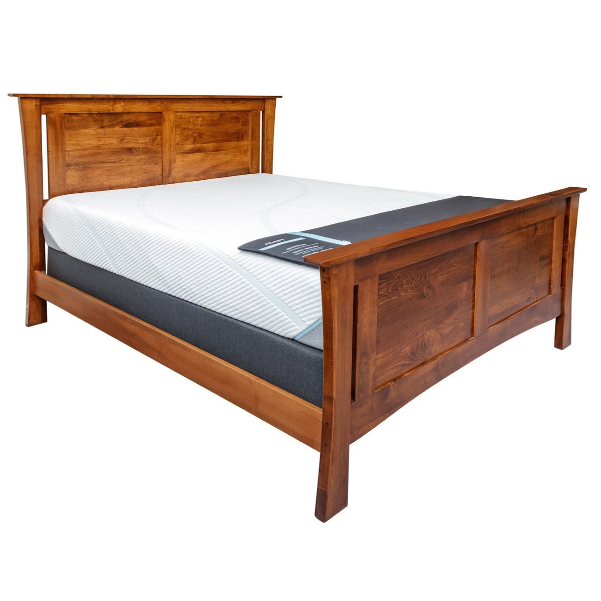 Modern panel bed in warm brown maple with a mattress in place, showing angled legs and wide rails