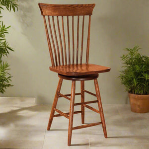 Oak Windsor swivel bar stool with spindle back, curved crest rail, saddle seat and angled legs with footrests