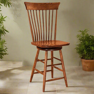 Oak Windsor swivel bar stool with spindle back, curved crest rail, saddle seat and angled legs with footrests
