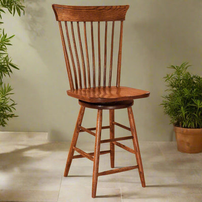 Oak Windsor swivel bar stool with spindle back, curved crest rail, saddle seat and angled legs with footrests