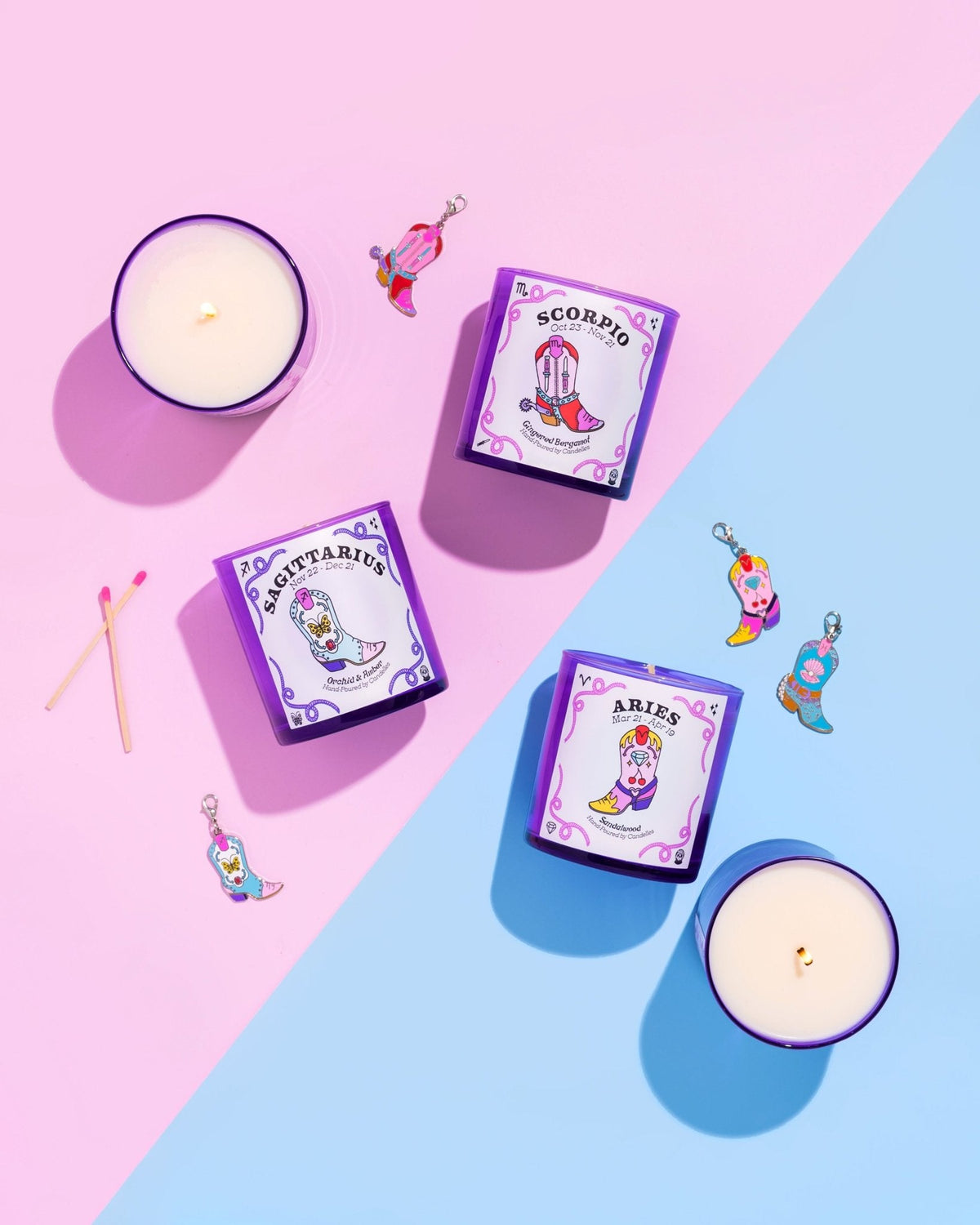 Sagittarius, Scorpio and Aries zodiac candles with cowboy boot charms and matches on pink and blue paper