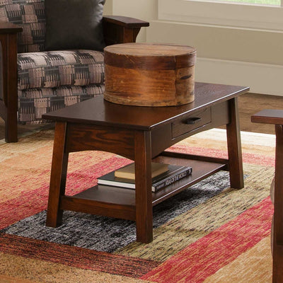 Santa Fe coffee table in dark brown with drawer, holding a wooden pantry box with atlas books on the lower shelf