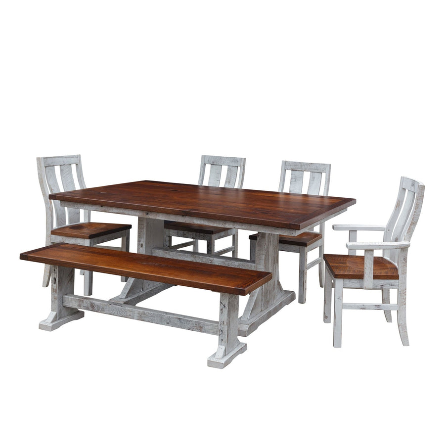Trestle dining table set with warm brown tops and distressed white trestle bases, four side chairs, one arm chair and a bench