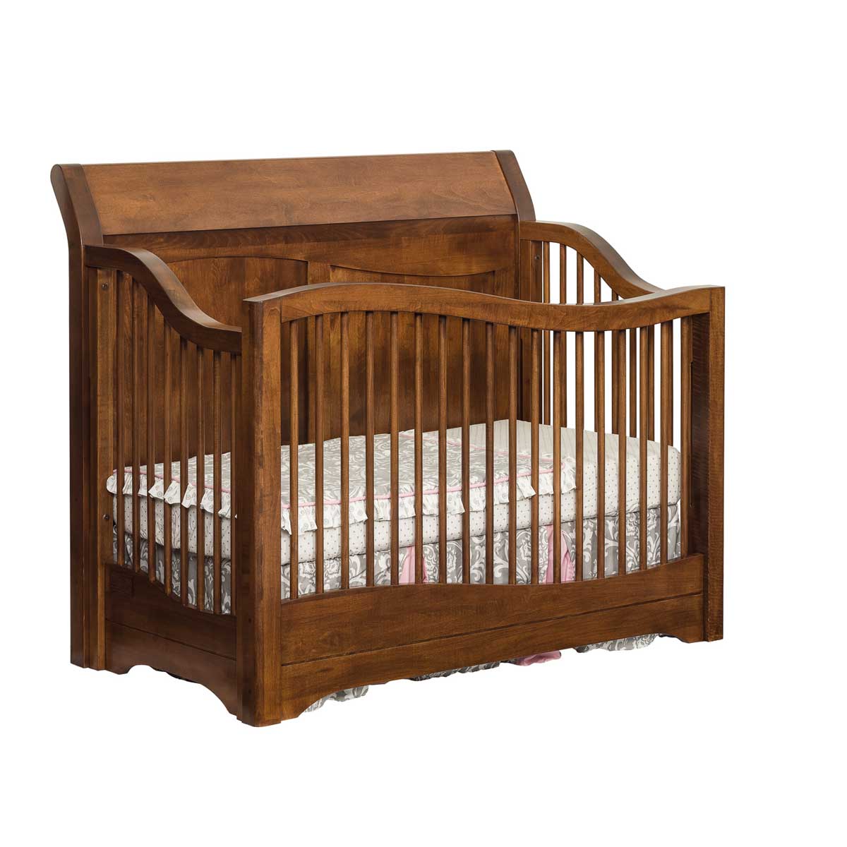 Brown maple sleigh crib with an arched paneled headboard, curved spindled sides and shaped skirt panel