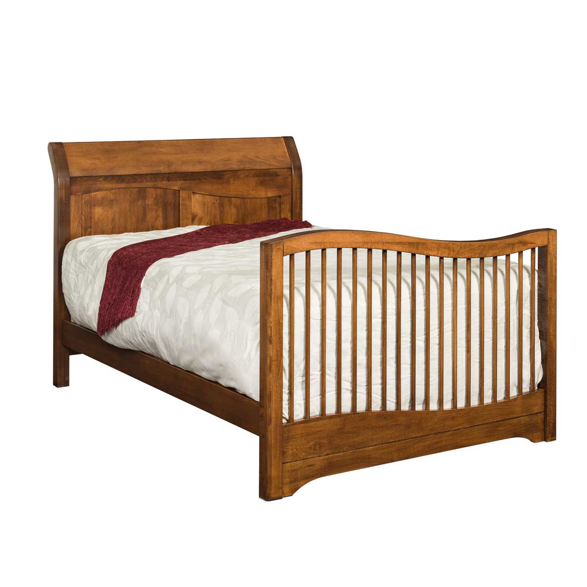 Sleigh crib converted to a full size bed in warm brown maple with curved headboard and spindled footboard