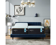 Split king cooling mattresses on adjustable bases in a navy upholstered bed with a gold globe chandelier above thumbnail