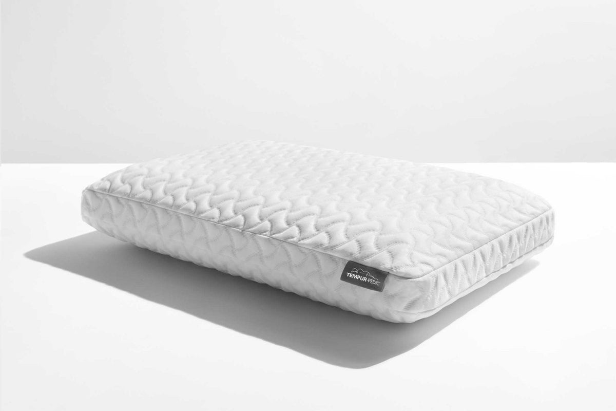 Two-in-one bed pillow with a textured quilted cover shown at an angle on a white background with soft shadow