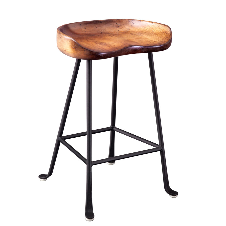 Counter height tractor seat stool with a contoured walnut toned wood seat on splayed black cast iron legs