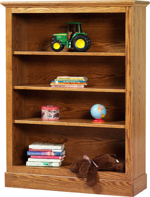 Golden oak kids bookcase with three shelves holding books, a globe, toy tractor and stuffed dog