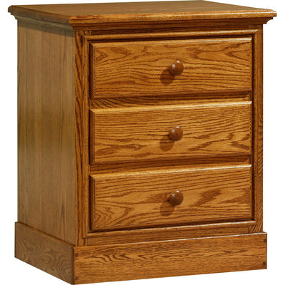 Three drawer solid oak nightstand in a medium golden finish with round wood knobs and a molded base