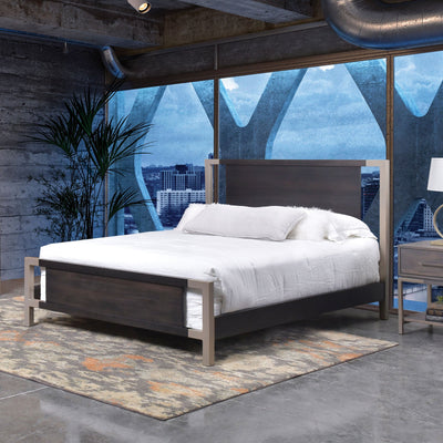 Metal-framed platform bed with a dark wood headboard and footboard panels and white bedding in a city loft