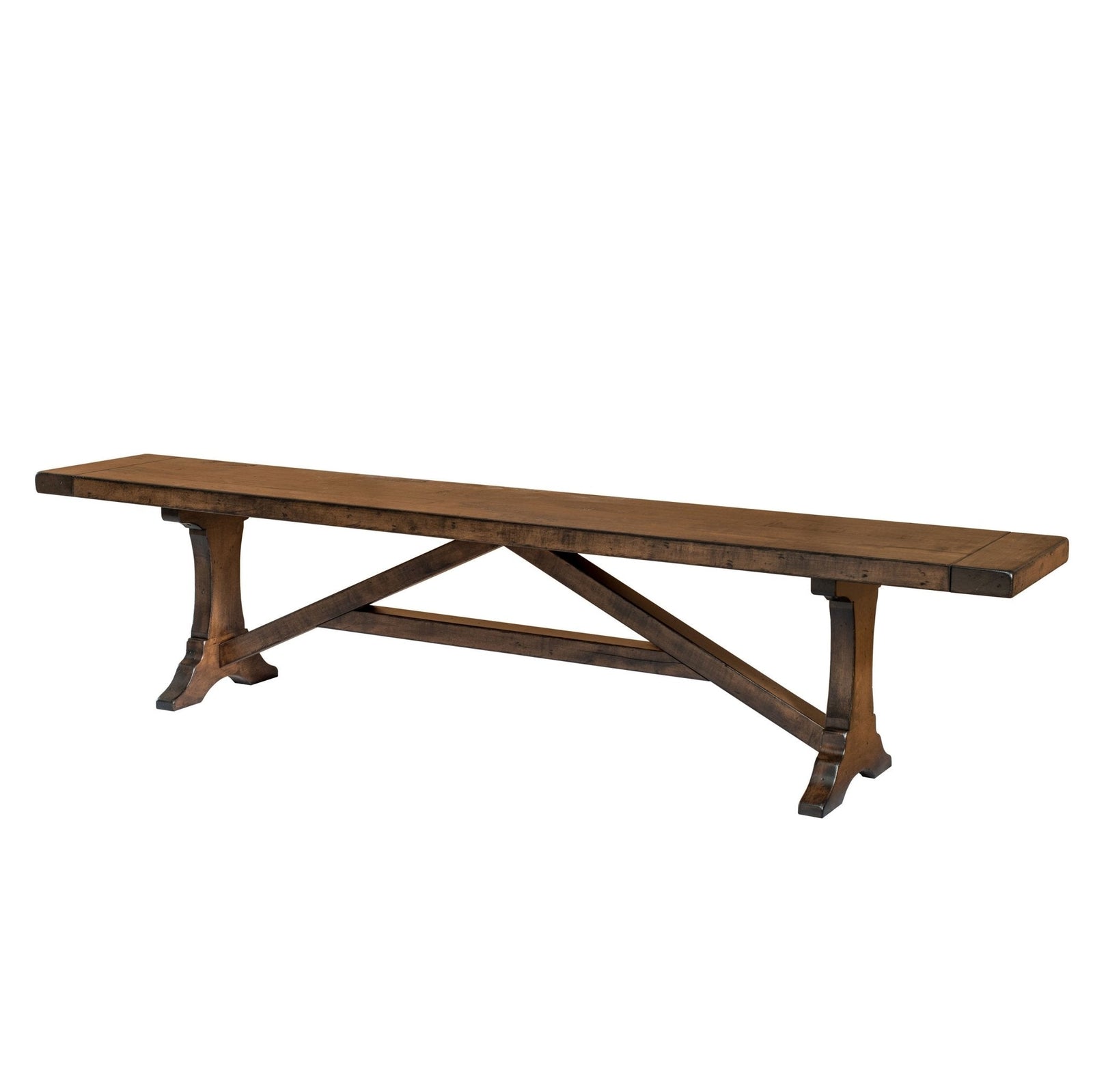 Westin trestle dining bench in warm brown maple beside a matching trestle table set with yellow dishes and flowers