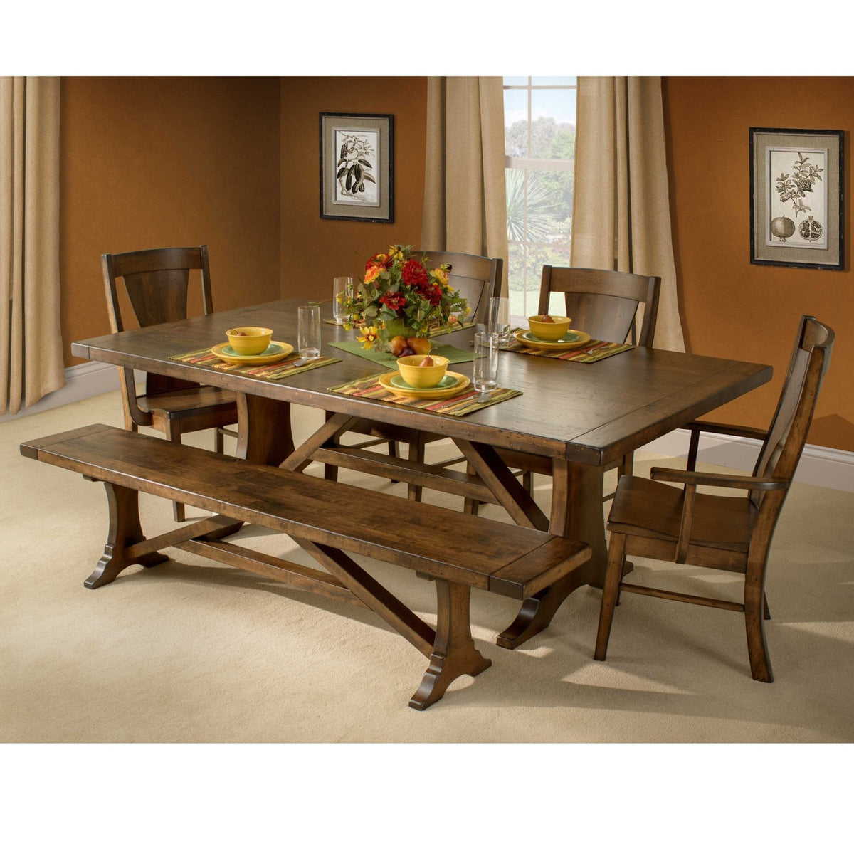 Westin trestle table dressed with yellow bowls, glasses and a fall bouquet, flanked by panel back chairs and a bench