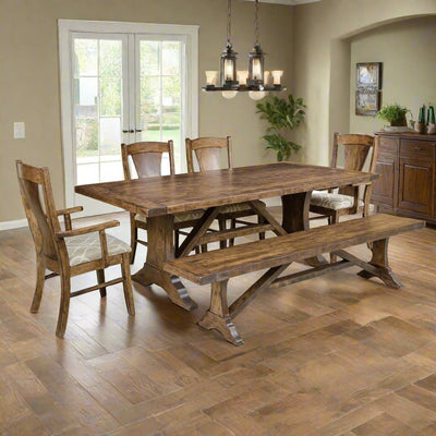 Westin trestle dining table with bench, panel back chairs and arm chair under lantern pendants in a tiled dining room