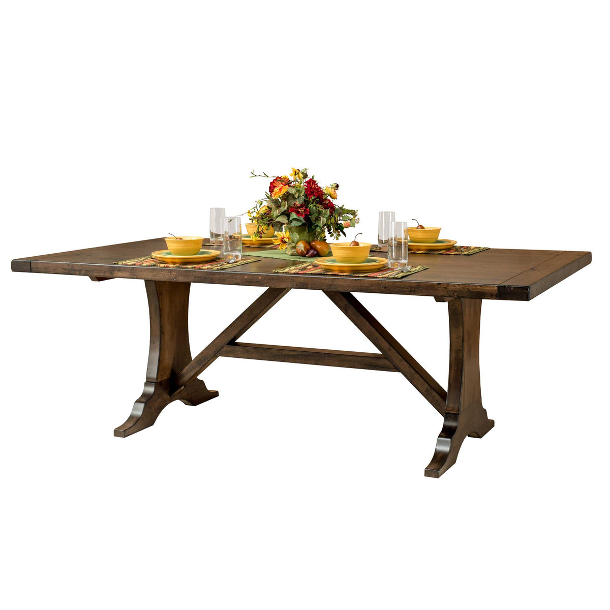 Westin trestle table with leaf in place, set with yellow dishes, glassware and a floral centerpiece