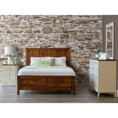 Panel bed with raised-panel headboard and footboard in a rich brown finish, styled in a stone-walled bedroom