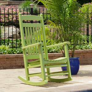 Lime green poly rocking chair with slat back and curved seat beside a blue planter on a paver patio